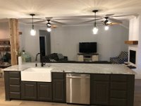 Here is a look at the kitchen island from the "working" side.  We modified the existing cabinet from the orginal kitchen to accomodate the farmers sink.  Cabinets on the right side of the island were originally under the "L" portion of the original kitchen.  Wall where fridge was originally has been removed and replaced with an old post from a barn.