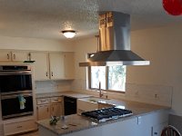 Here is the end result.  We removed the soffit over the cook area, ran a gas line for the new gas cook top, relocated electric to area where fridge was to allow for install of new double oven in the custom cabinet we built.  We also reworked the sink cabinet to accommodate the new farmers sink and built a custom cabinet under the new gas cooktop that has 2 large drawers for pots and pans storage.  Granite, backsplash and new paint on the cabinets and walls complete the remodel.  Total remodel time was 35 days with the family of 6 living in the house.