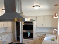 Here is a better view of the new double oven installed in the custom cabinet we built, as well as the functional vent-a-hood over the new 5 burner gas cooktop.  Also, you can see the copper kitchen sink faucet and matching copper pendant light over the sink.
