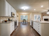 Here is a view of the kitchen, looking from the dining room.  All new custom cabinets, countertops and backsplash.  All new texture throughout the house as well as windows, floors, paint, electrical plugs and switches, light fixtures and fans, plumbing fixtures.